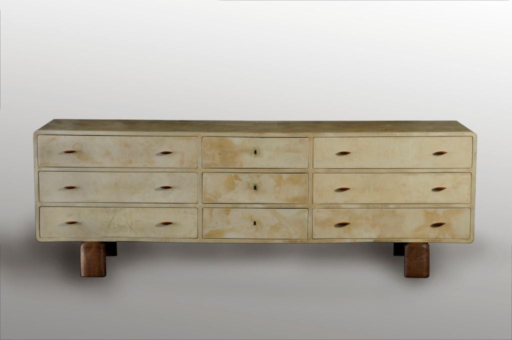 Chest of drawers covered in parchment with walnut handles and sculpted walnut feet by the italian designer Guglielmo Ulrich. It is  documented in ' Il mobile Deco Italiano' - I. DE Guttry and as it has identical markings, it is probably the one