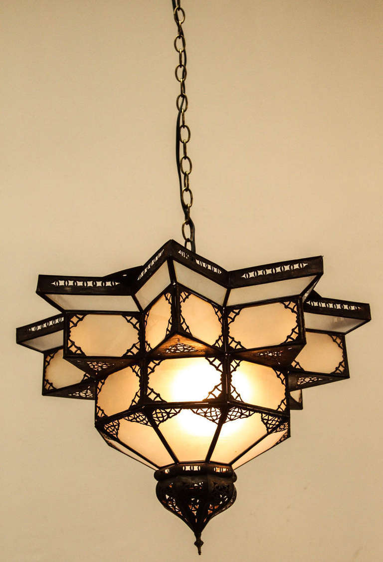 Moroccan Hanging Lighted Star Pendant
Metal frame and frosted glass with delicate filigree metal work on this hanging star pendant. 
Rewired ready to install.
Size of the star shade is 23