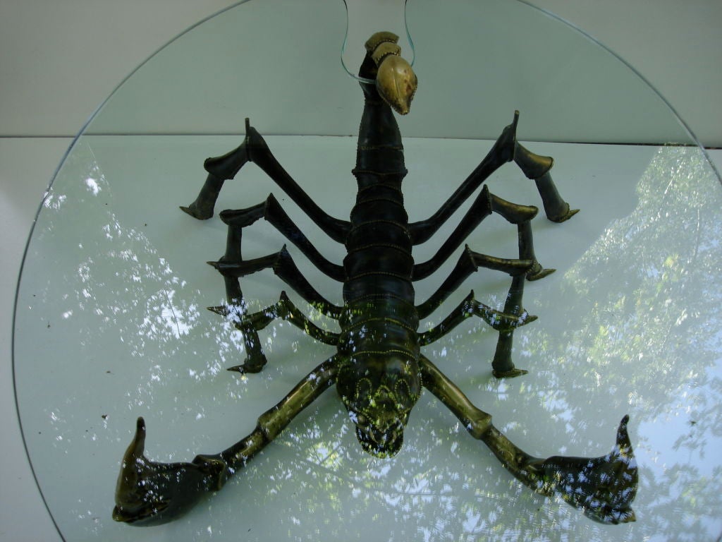 Scorpion bronze table with a lamp in the tail which curves above the table itself. Table attributed to Jacques Duval Brasseur. 

Exceptional piece and it is a one-off and by the quality as well as the techniques used.