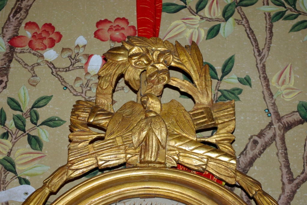. Gilded carved wooden framework
. Decoration of an eagel surrounded by a flower foliage
. inscription: 