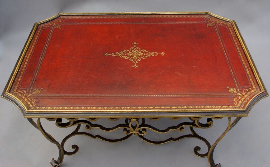 . A gild wrought iron coffee table
. Red leather top
. 19th century