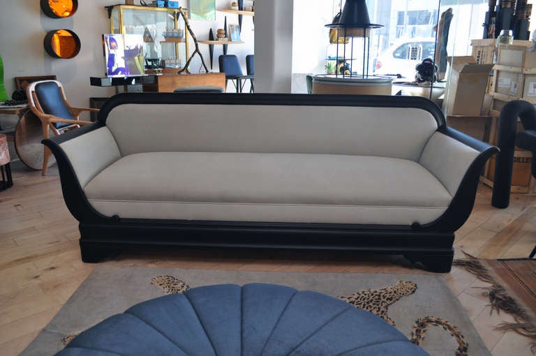 American Empire Style Sofa.  The mahogany frame has been exquisitely  ebonized. The upholstery is covered in a beautiful bone color ultra suede  from Maharam kvadrat textiles.