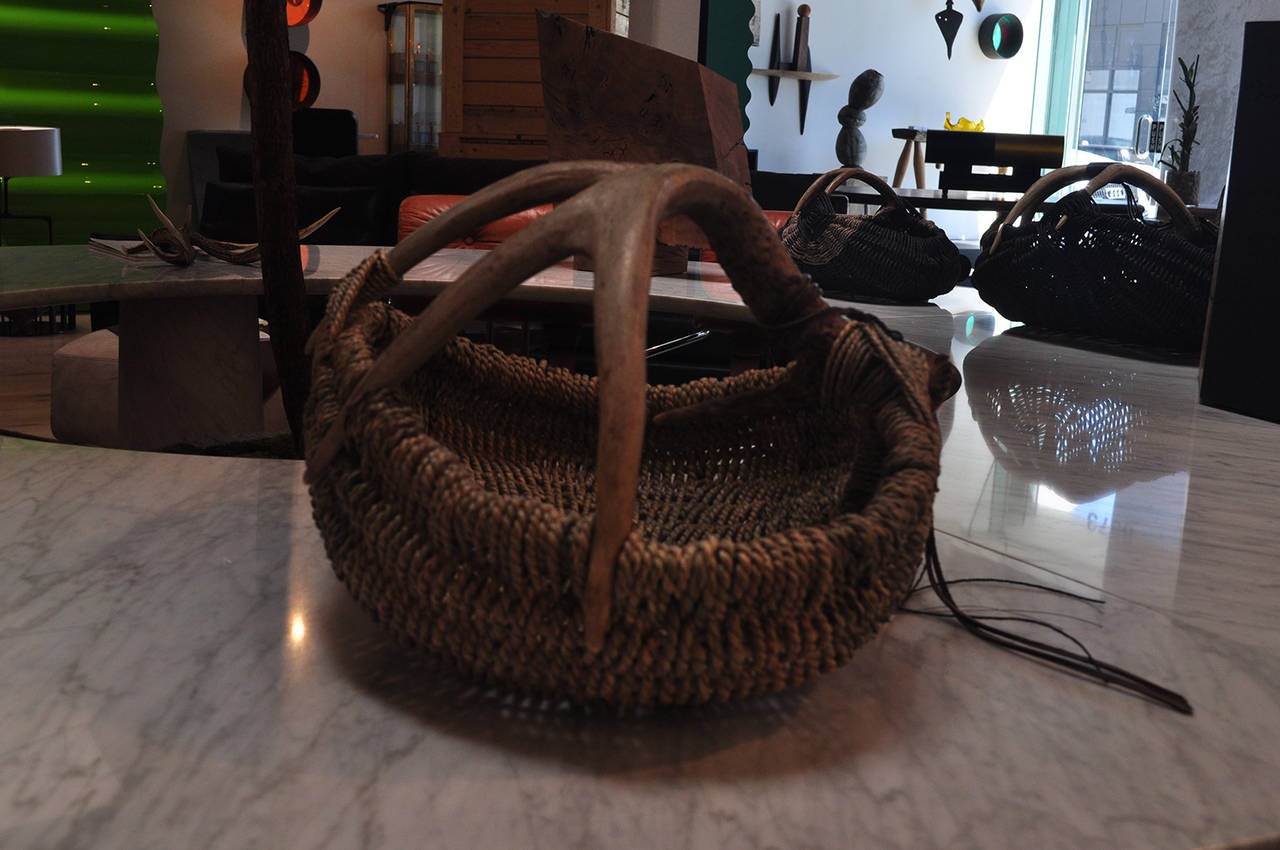 This custom deer antler basket, featuring hawk feather, jade, pyrite, and labradorite details, was made by artist Dax Savage. Savage is a Los Angeles based jewelry designer and artist whose career started over 20 years ago out of a fascination with