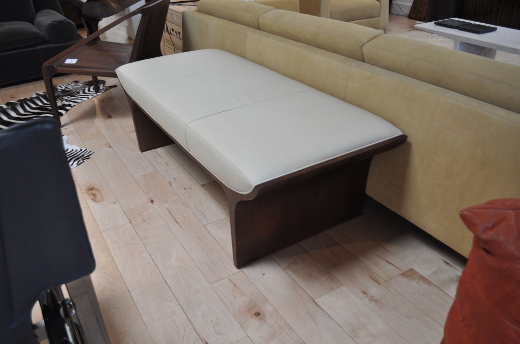 Fully upholstered bench with three panel seat cushion. Laurel Bench delivers unparalleled elegance to any waiting room or lounge area. Designed by Mark Goetz. Available in various fabrics, leathers, and finishes. COM and COL available.