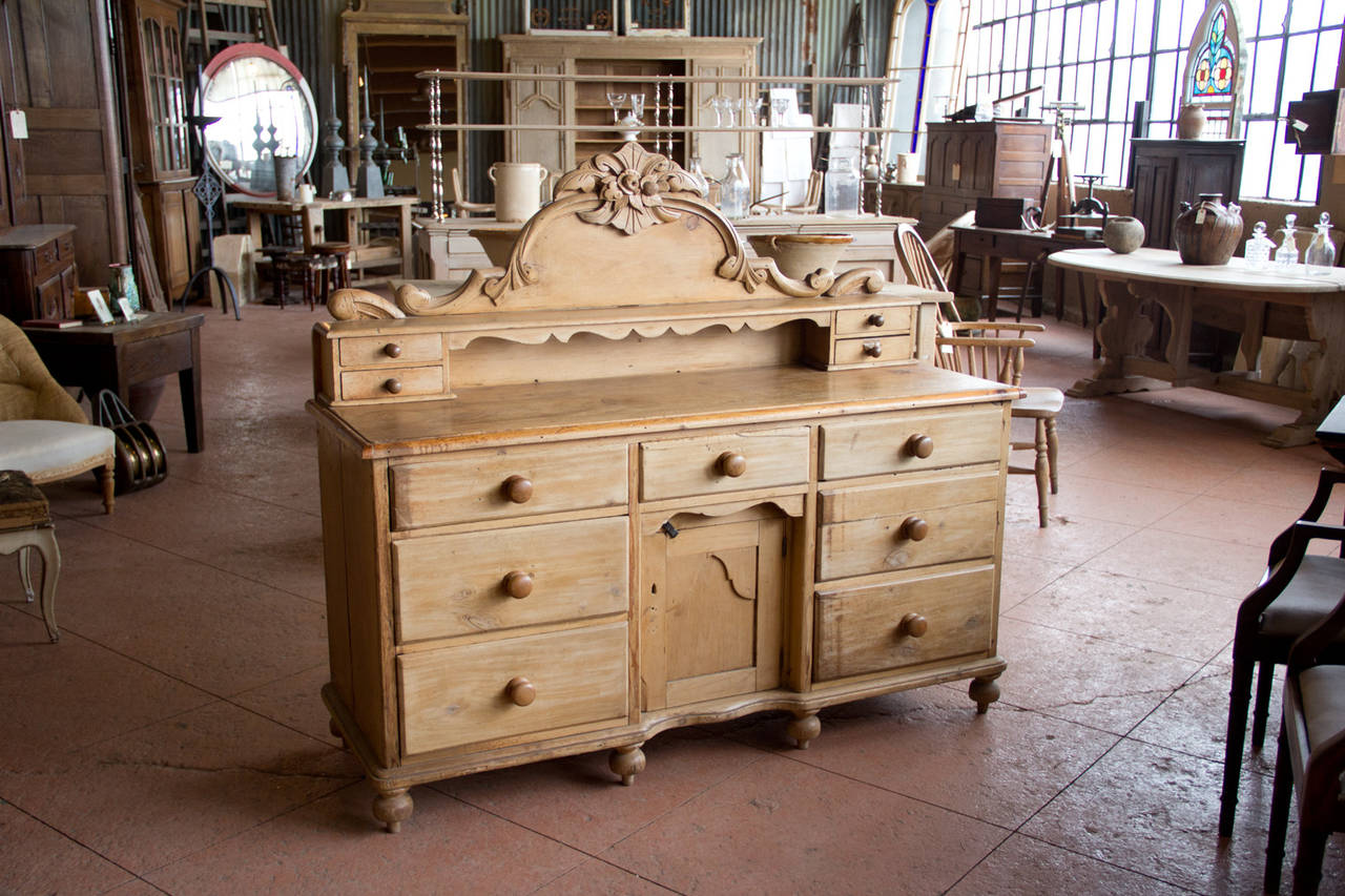 Victorian Scottish pine sideboard with decorative back, 11 drawers and one cupboard door.

Counter height: 32.5