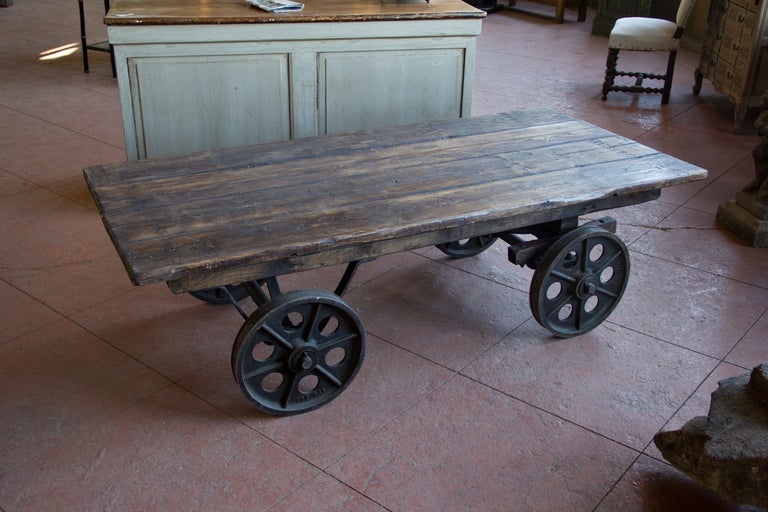 Fantastic vintage British industrial mill cart. The chassis is original, but the top has at some point been replaced with antique reclaimed wood.  Perfect coffee table.