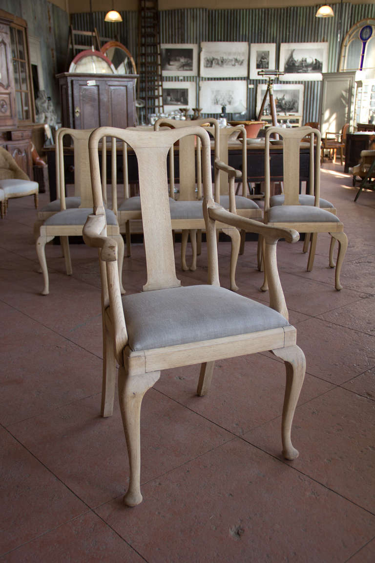 Great set of 8 1920s oak Queen Anne style stripped back dining room chairs.  The set has 2 captains chairs and have been reupholstered in light grey French linen.

Take a look at the oak stripped back table that looks wonderful with the chairs and