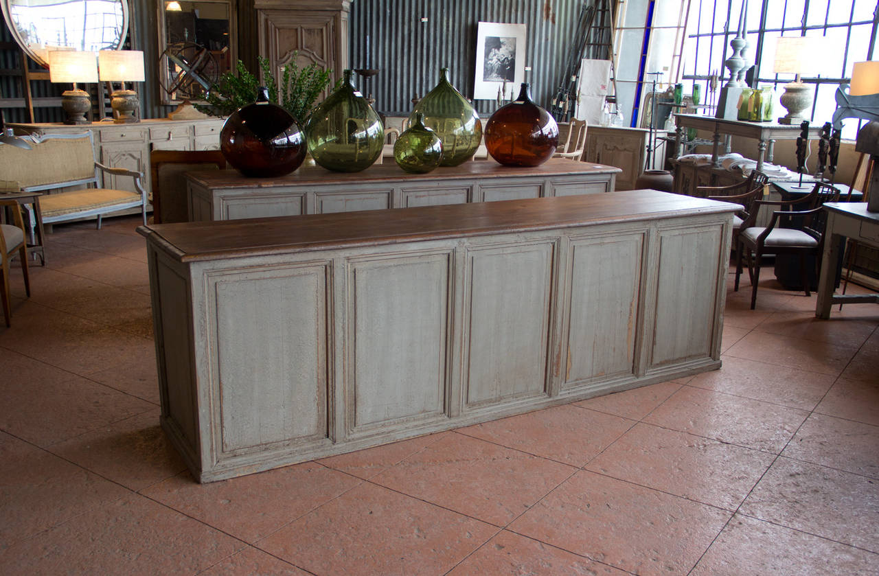 Beautiful and substantial antique painted French shop counter. We currently have another available as a near pair. The price is for one.

Would make exceptional kitchen islands.