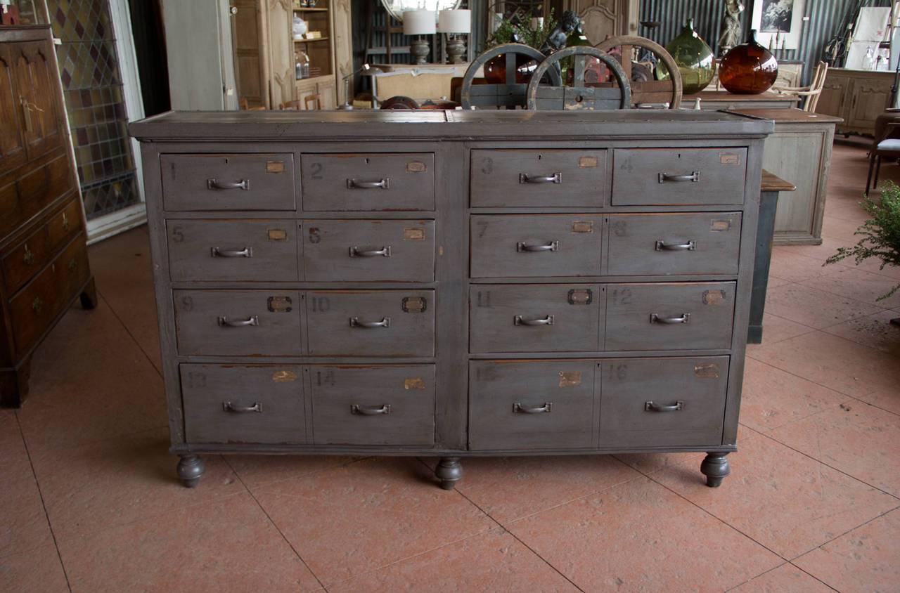 Beautiful substantial antique painted pine bank of numbered drawers with riveted top. This unit started life as two chests and at some point were married together.