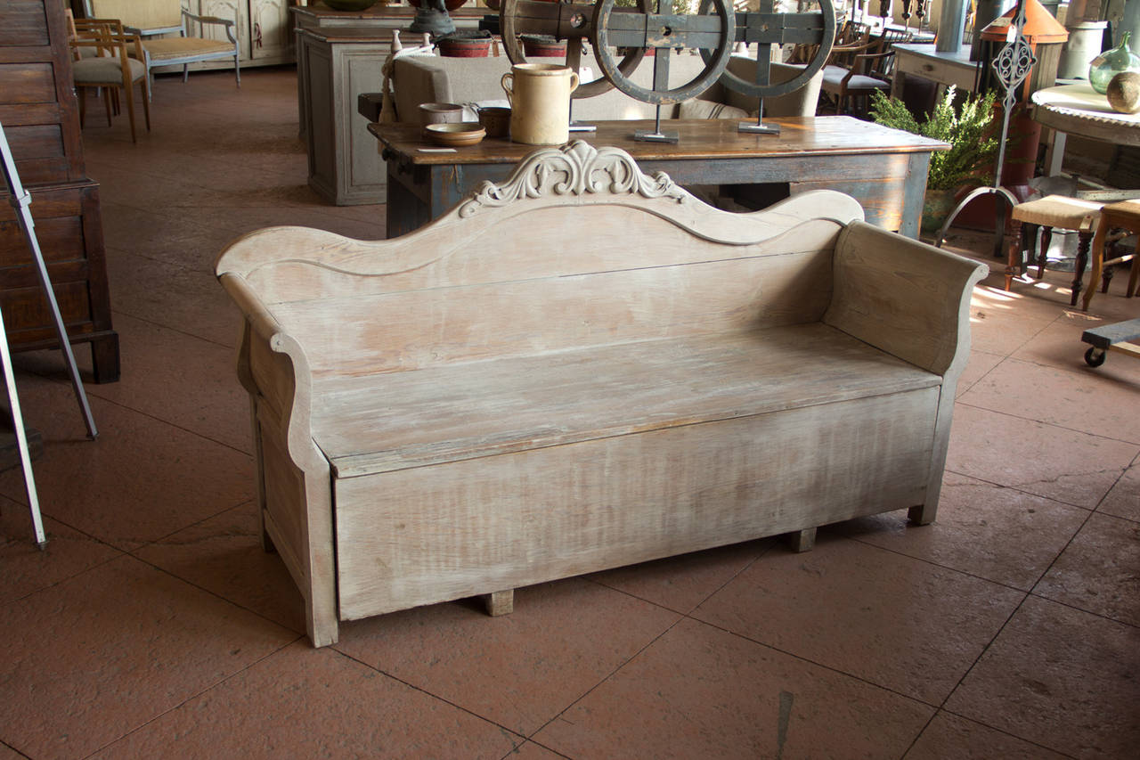 Antique Gustavian Style whitewashed bench with lovely scroll arms and carving to the top. The seat lifts up for convenient storage.