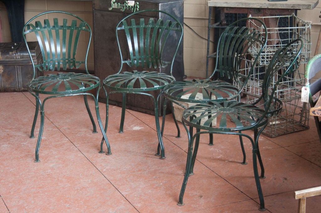 Set of 4 French wrought strap iron garden chairs, with sprung hoop shaped back on circular sprung seat.