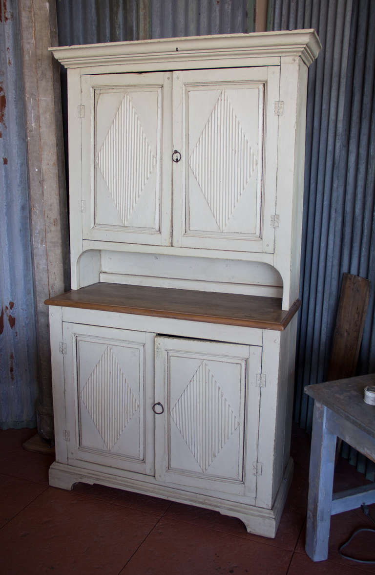Lovely 19th century painted Gustavian cupboard with typical raised diamond pattern to the 4 doors.