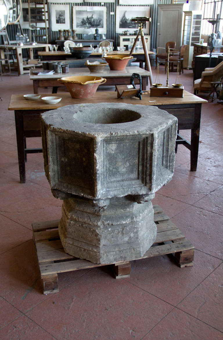 Beautiful antique font.  It has 8 paneled sides and 8 beautifully carved bosses. There is a stonemason's mark of a cross on the top ledge. It is our thought that the font would have been elevated in order to see the bosses (which you often see on
