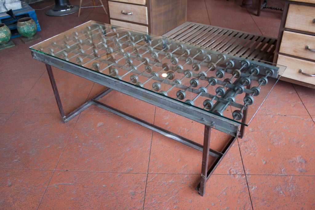 Funky industrial table made from original conveyor. Base and glass have been added.