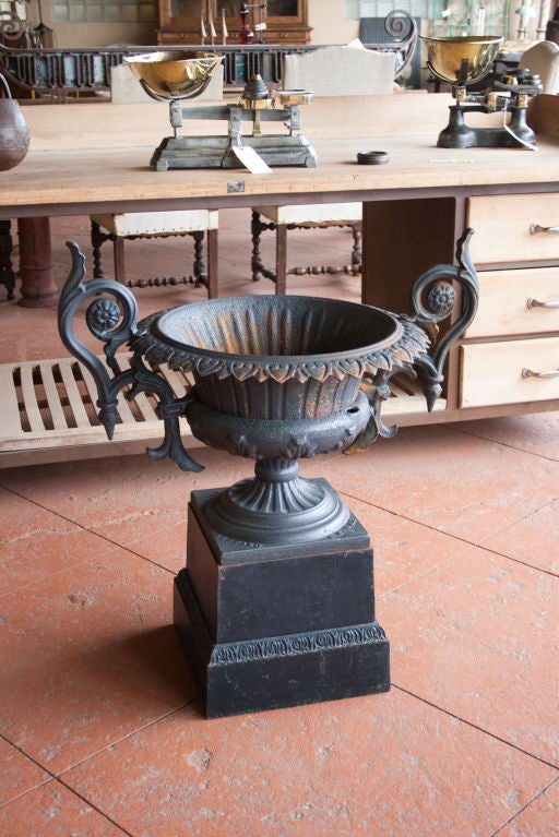A stunning antique American cast iron urn on on its original plinth. Beautifully scrolled handles makes this a show stopper!  Dismantles down to 6 pieces.