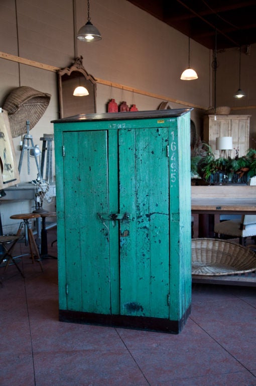 Very unique Argentinian double door train station locker. Wonderful distressed green finish with its original hardware and litho numbers. Great size and a very usable piece of furniture.