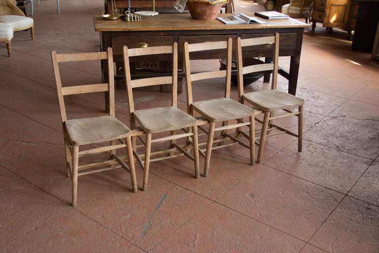 Antique Welsh elm chapel benches made up of 4 chairs joined.  If they would suit you better as single chairs, they can be separated.

We currently have 2 benches available.