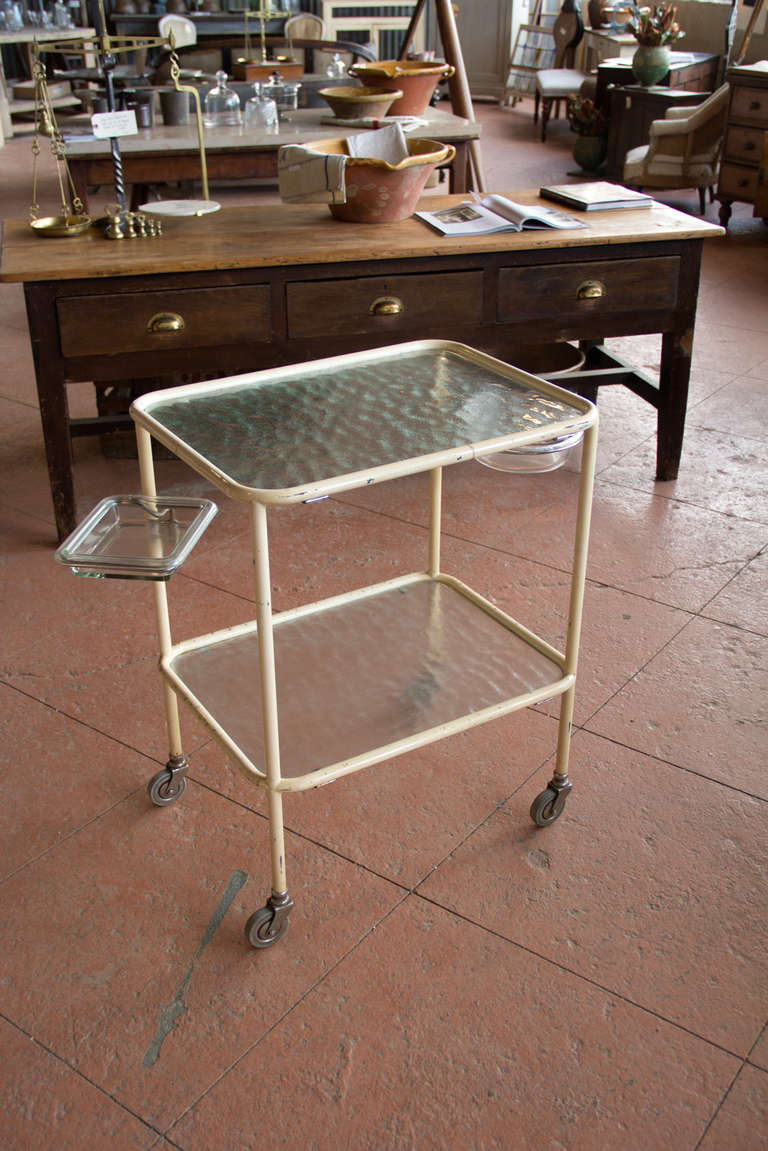 Wonderful Mid Centry metal trolley with its original casters. It has glass shelves and bowls. Found in France