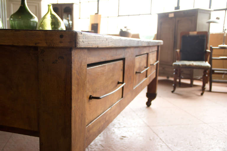 Rare substantial baker's table with it's original castor wheels.