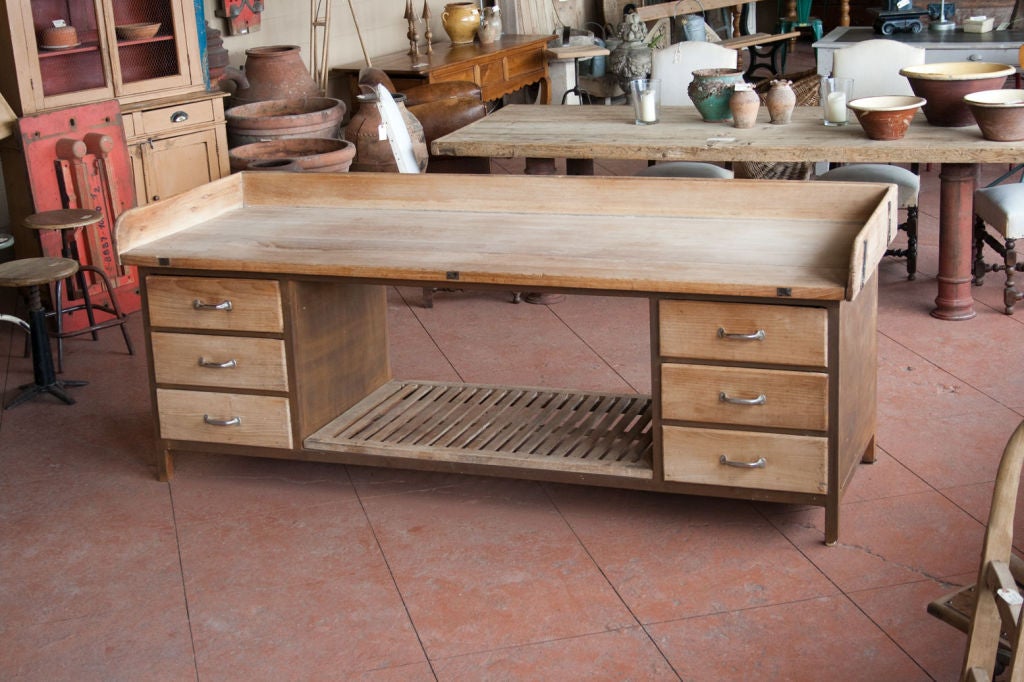 Large wood and metal baker's table from a commercial bakery in Belgium.  The table has 6 heavy drawers with a slatted cooling shelf to the bottom.  A perfect kitchen island.