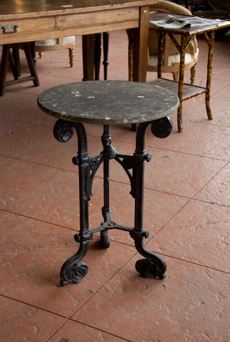Beautiful Regency tripod table with stone top and cast iron tripod base.