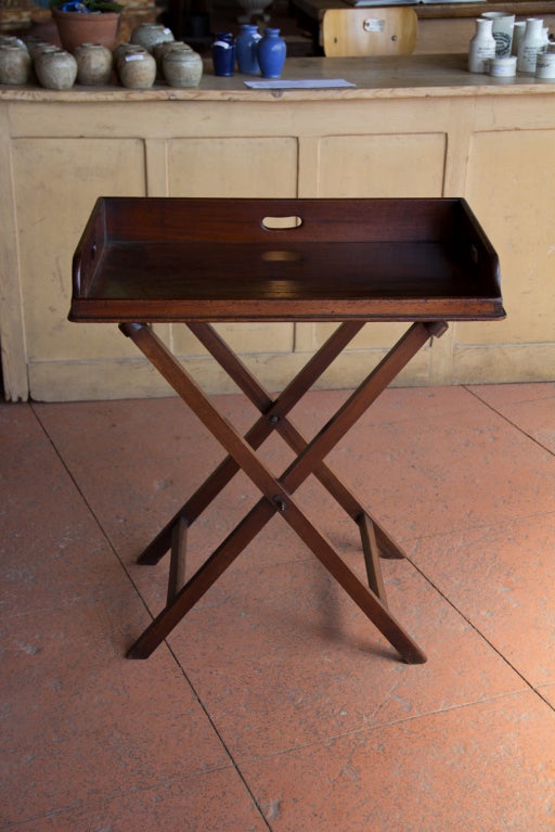 A beautiful late Georgian mahogany open fronted butler's tray on an x stand.  The colour is wonderful. A little cracking to the tray and priced accordingly.