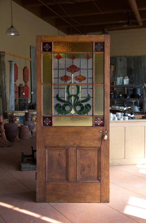 Beautiful stained glass art nouveau hall door
The colours are burnt orange, green, amber, yellows and ruby red quadrants that are cut to show off the clear glass underneath. 

A perfect office, pantry, hallway, bathroom door!