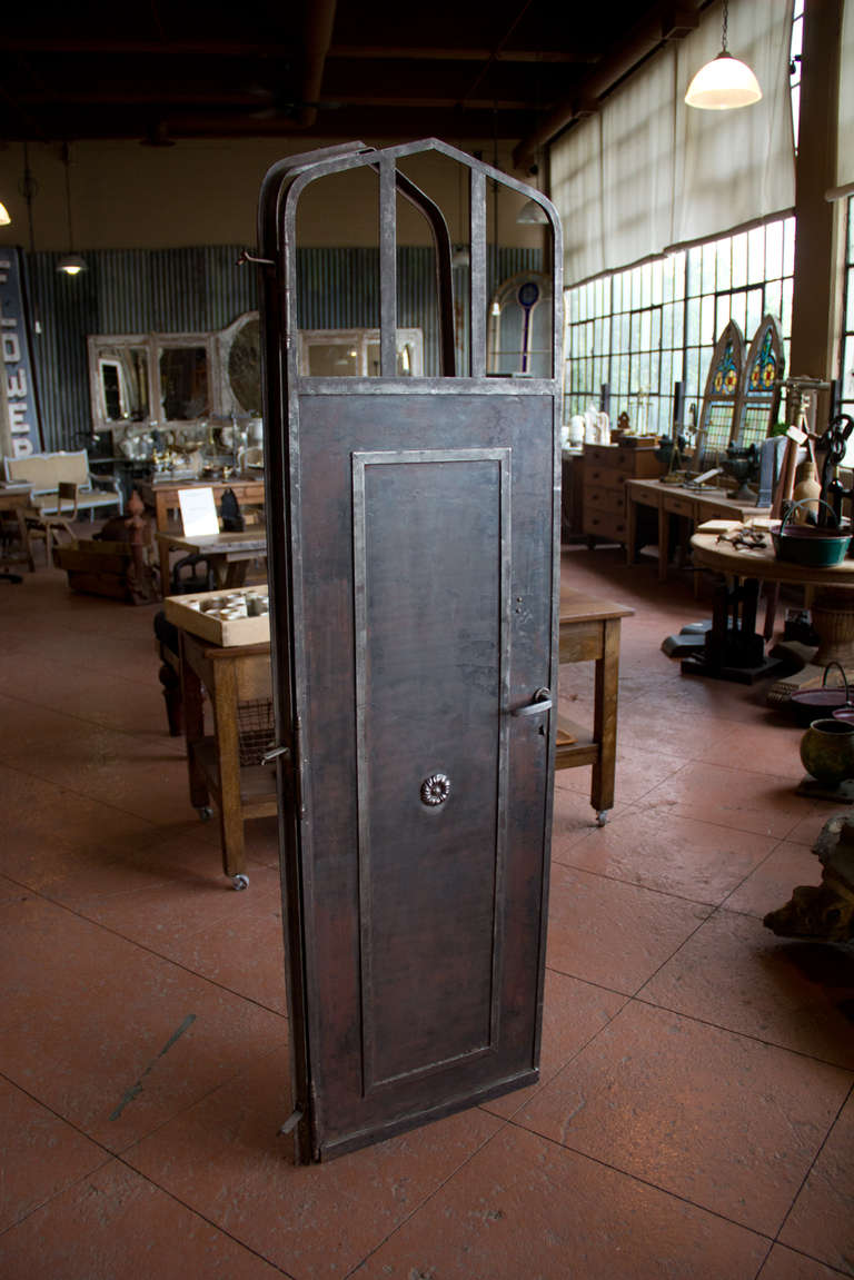 Funky antique metal door and frame with a slow arch top - no glass.  Great patina.