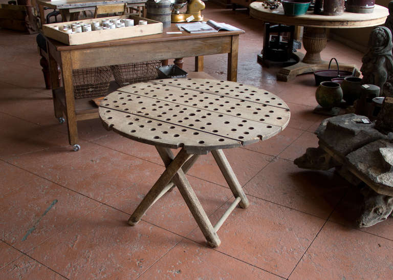 This table is a marriage between a fruitwood circular wine press interior  sitting on an oak saw horse, both from the wine region of Burgundy.