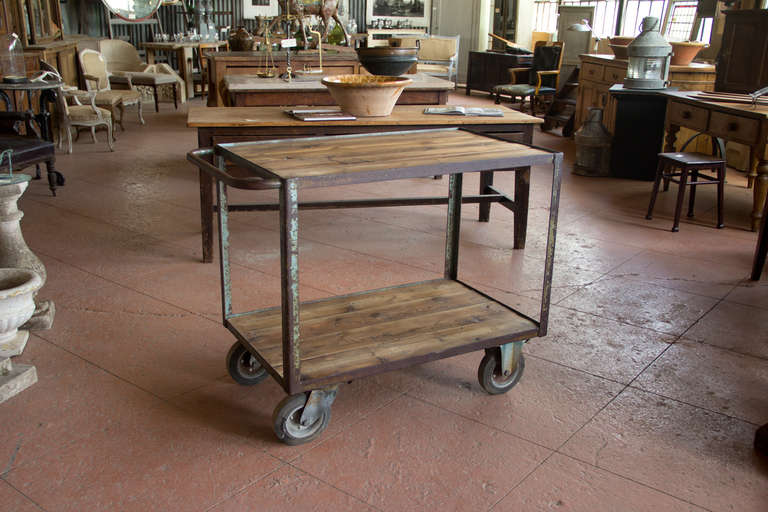 Vintage industrial metal factory cart with its original wheels It has been fitted with reclaimed wood shelves.