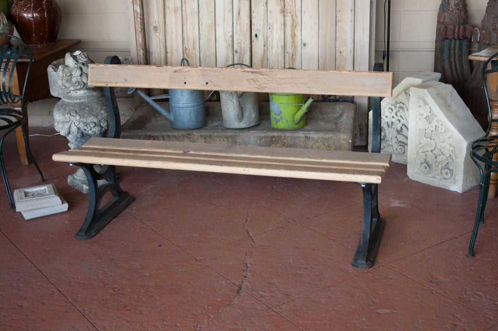 Very substantial Victorian cast iron promenade bench bearing inscription of the foundry maker W. Barker, Harrogate.  The original slats were rotted and we have replaced them with antique salvaged wood.<br />
2 available.