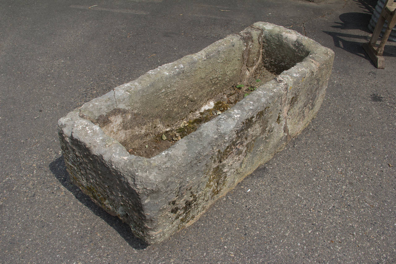 Large antique English hand-hewn stone trough with beautiful patina and markings.