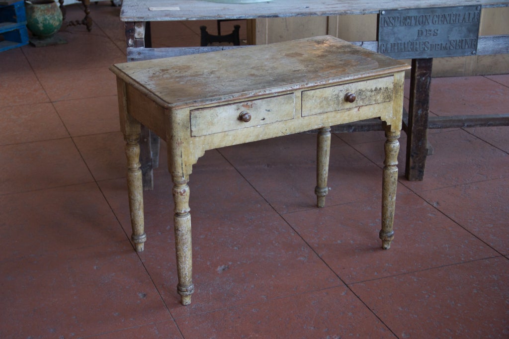Gorgeous rare Irish pine desk with its original paint, turned legs and stylized apron front.
