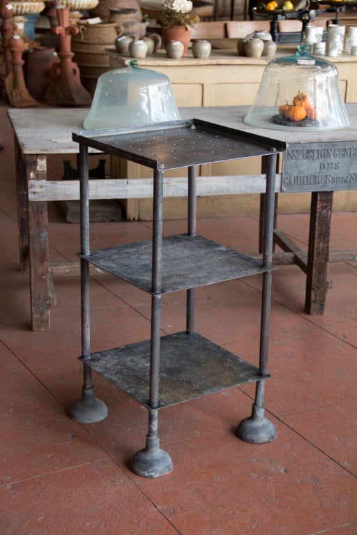 Fantastic and unusual 3 tiered industrial factory shelf made from heavy gauged iron.  This is a very interesting piece!