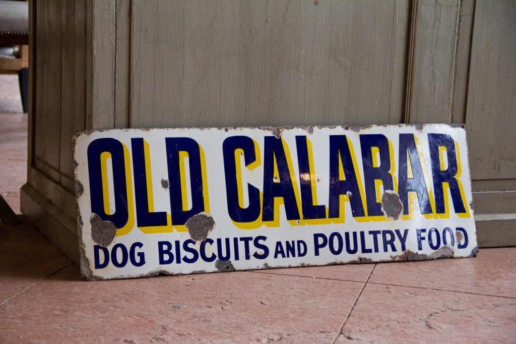 An English vintage enamel Old Calabar dog biscuits and poultry food sign from Liverpool, England.