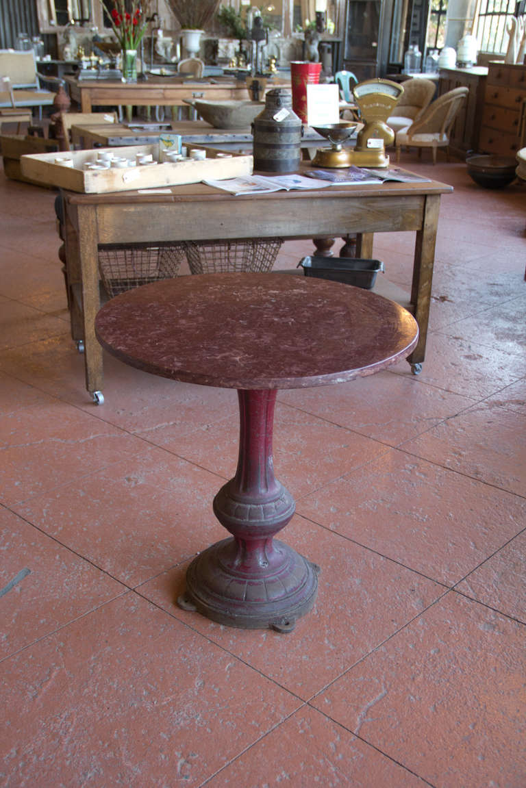 Beautiful Victorian cast iron pub table with its original burgundy paint and old rouge marble top by T.J. Griffiths of Liverpool, UK.