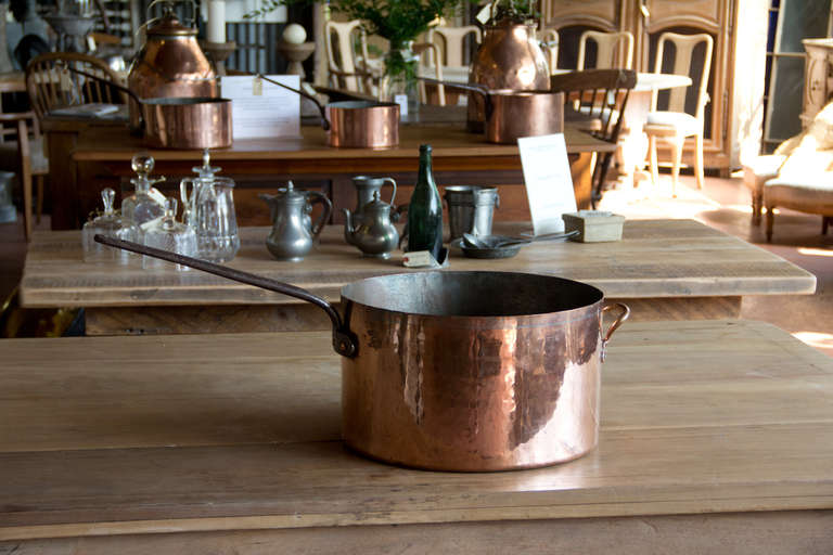Very large late 19th century commercial copper cooking pot with riveted copper handle and wrought iron handle. The maker's garter or stamp is prominently impressed onto the side of the pot. Handmade by 