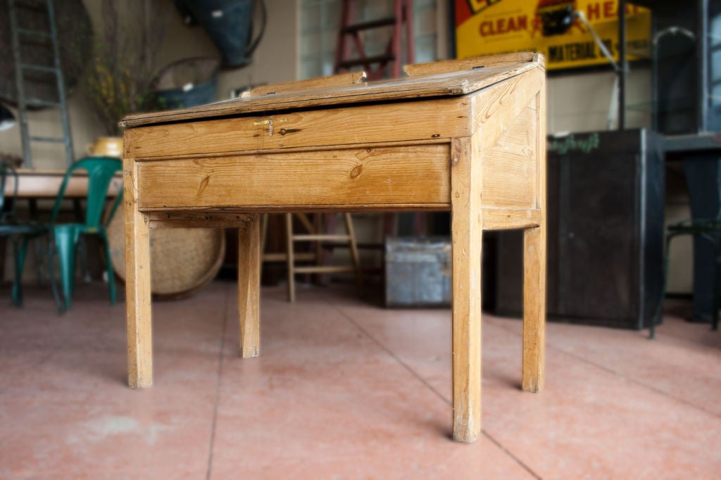 Large and very solid early 20th century industrial sloped front pine desk.
