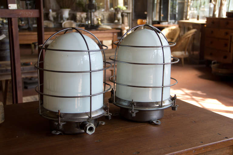 Lovely large vintage nautical light with milk glass and fantastic chrome cage.

2 pictured, but only 1 left in stock!