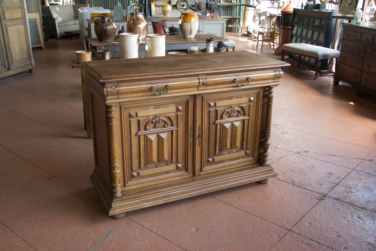 Henry II style walnut buffet with architectural panels and turned columns from the Louis Philippe period.