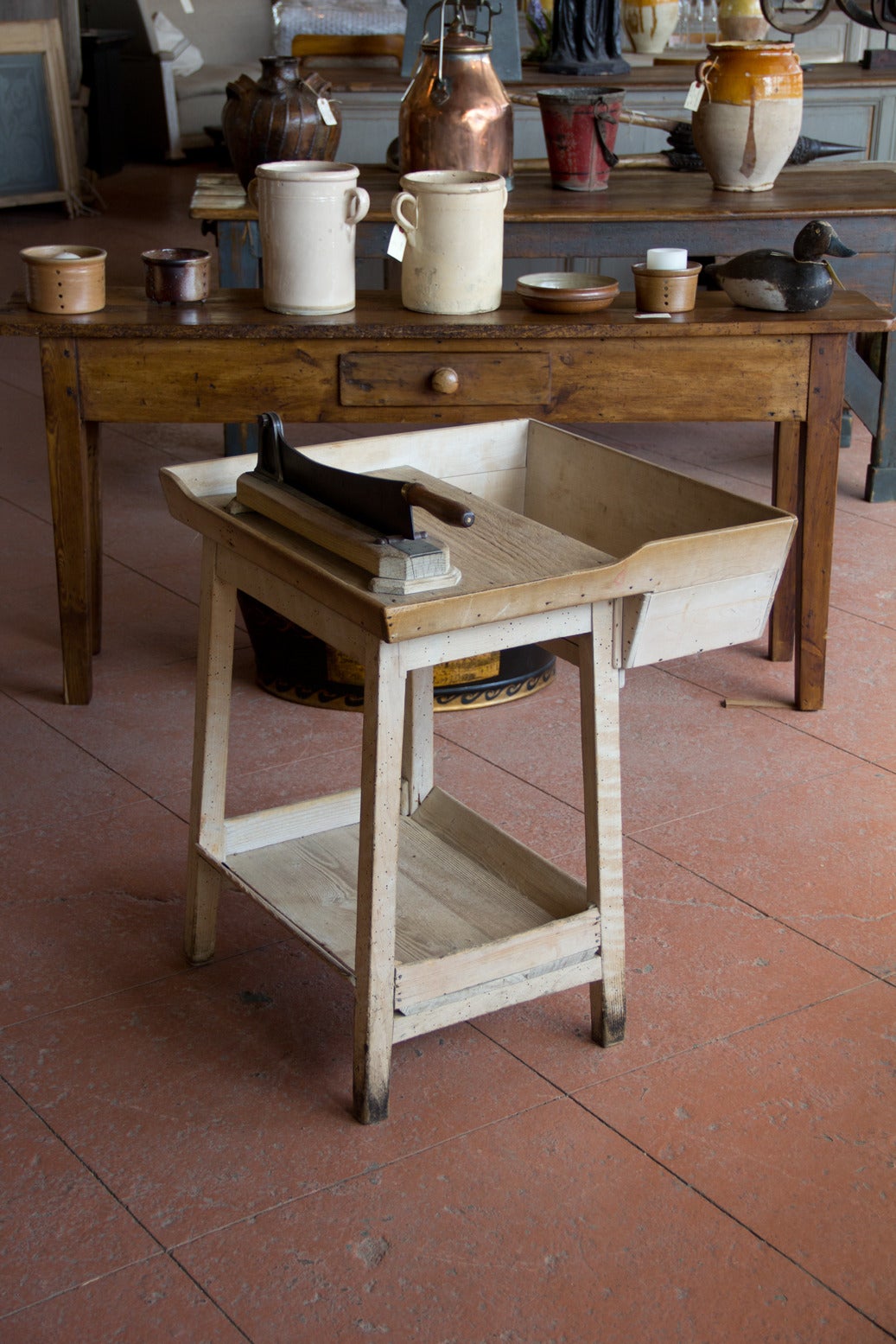 Antique French commercial boulangerie fruitwood bread cutting board and guillotine on a stand. It has a convenient hopper to the front and a shelf below.