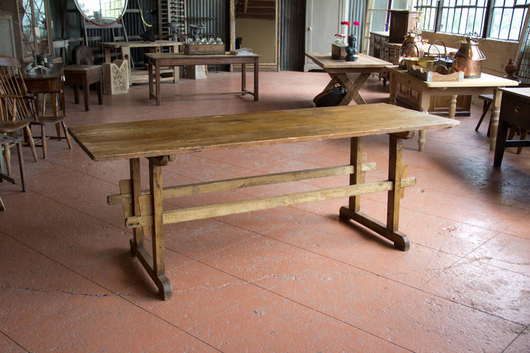 Antique rustic French trestle base preparation table with double H-stretcher base.