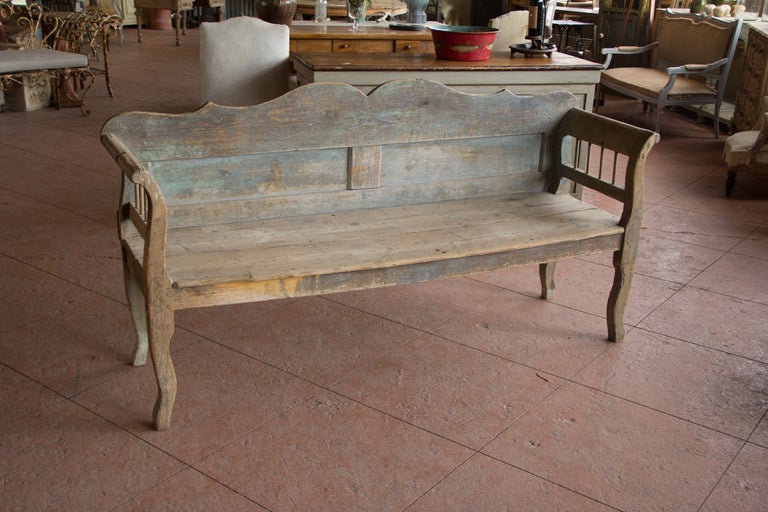 Beautiful Gustavian wooden bench with its original painted finish. It has lovely shaped legs and back with rolled arms.