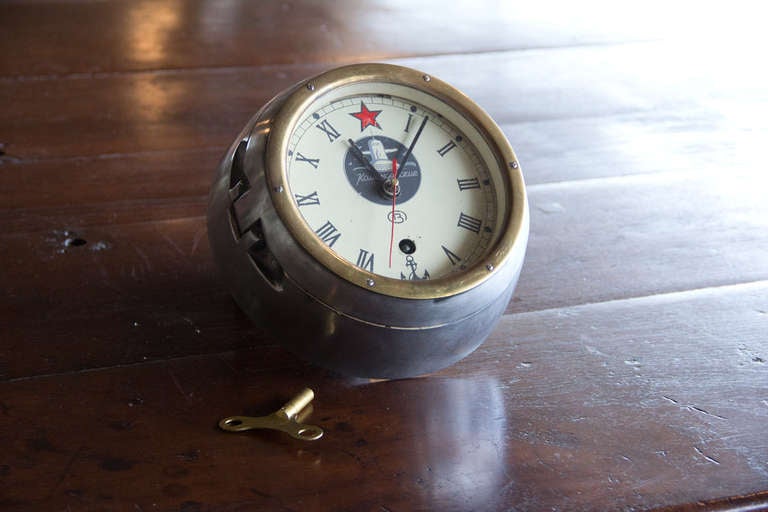 This is an original Russian submarine clock with 8 day jeweled movement. The heavy solid case is steel and brass with its original brass key.

We currently have 4 available - 1 of which has Roman numerals