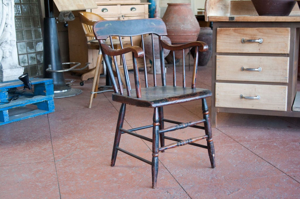 Lovely 19th century low stick back painted Windsor chair found in Pennsylvania. The chair has rolled arms and two beautiful turned  front stretchers.