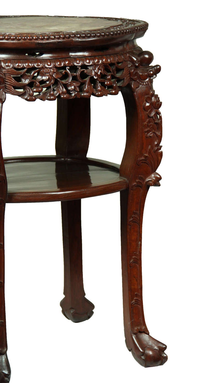 This table is of substantial size and is beautifully carved throughout. These tables came in many grades and this is one of the best. (Please see the detailed images to view the sharp quality of carving.) The wood is a red-brown eastern wood and the