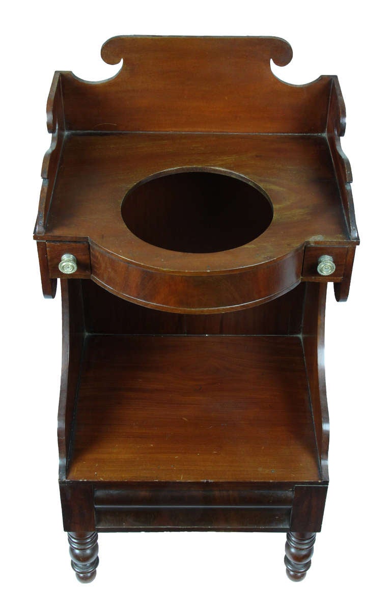 This washstand is in superb condition and finely executed. Note the dovetailing of the back splat to its upper sides (see enlargement). Except for the crotch grained veneer drawer front, the exterior is all composed of the solid. The possible