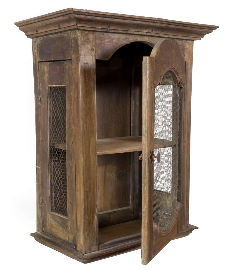 This is a utilitarian cabinet designed with side panels that open, in addition to the front door, which protects fruits vegetables, things ripening. This piece is very heavy and all of the structure is of dense quality and construction is pegged and