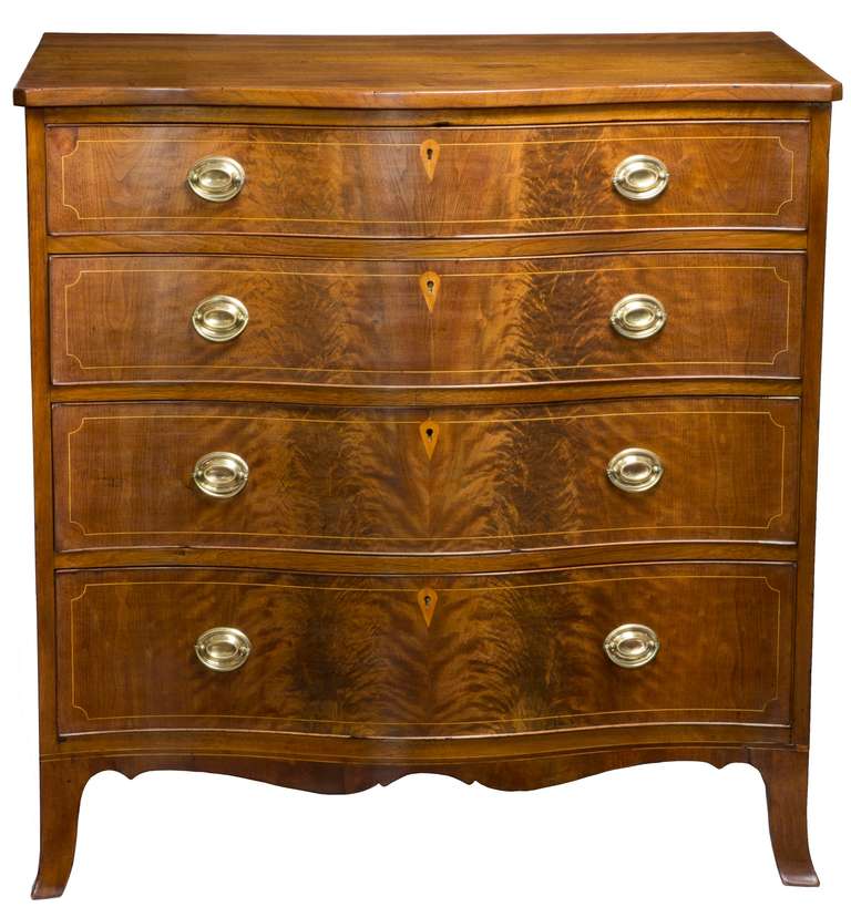 This compelling bureau has the advantages of (one) being 37 inches wide—which is on the smaller side and (two) being composed of walnut, which is far less common than mahogany. It is quite tall, and with its highly figured serpentine front, makes a