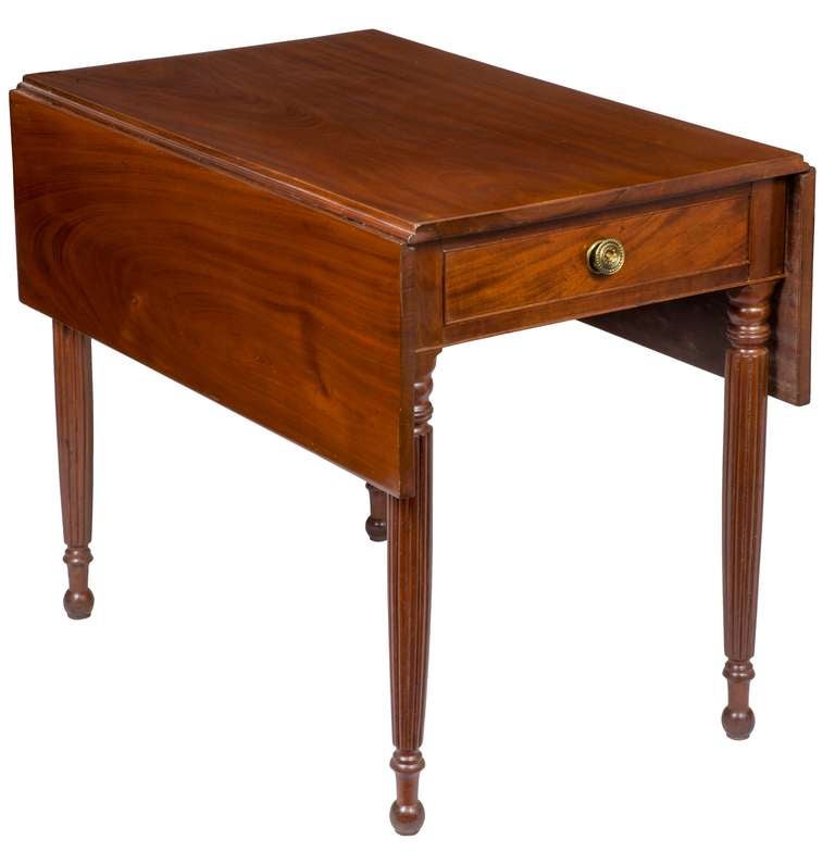 This table is composed of solid beautifully figured mahogany throughout. The top has small correct leaves and the feet are reeded with ball turnings at their end. Interestingly, this table bears a family history, (see below) and was deaccessioned